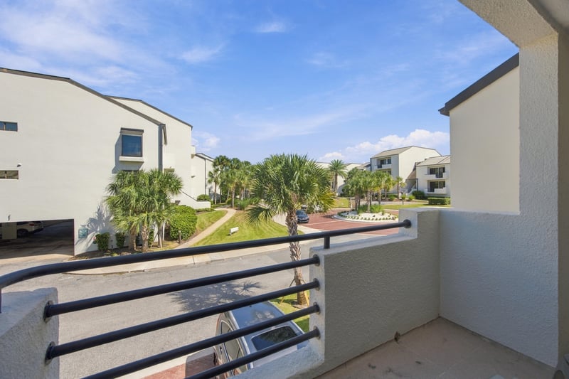 Balcony view of surrounding buildings and palms at 752 Spinnakers Reach Dr, Ponte Vedra Beach, FL 32082