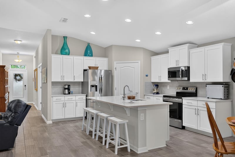 Kitchen with white cabinets and island at 4319 Green River Pl, Middleburg, FL 32068