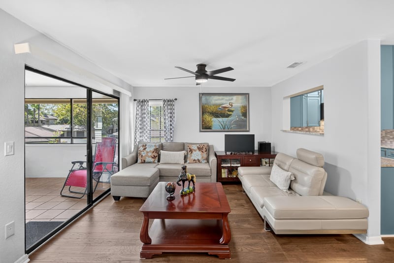 Living room with sliding glass doors and dining table at 10150 Belle Rive Blvd, Jacksonville, FL