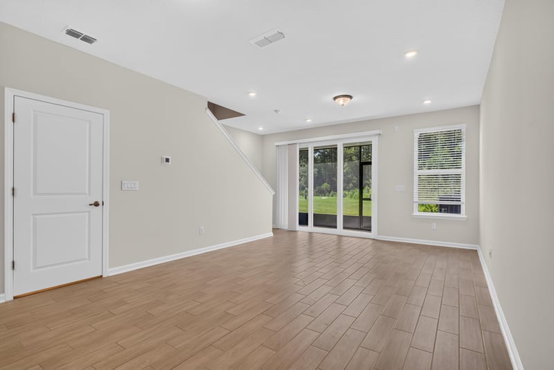 Living room with wood floor and sliding glass door at 39 Mellowood Ln, St. Augustine, FL 32092