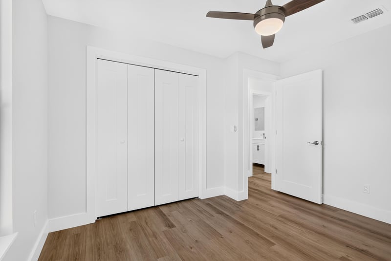 Empty room with closet doors and hallway view at 8453 Boysenberry Ln W, Jacksonville, FL
