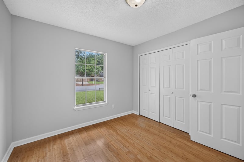 Bedroom with wood floors and window at 456 Bay Point Way N, Jacksonville, FL 32259