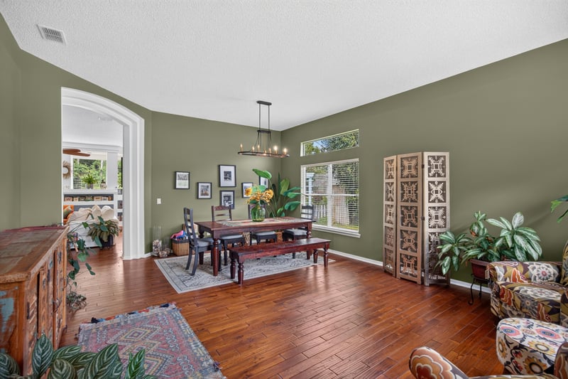 Dining room with wood table and green walls at 1820 Burgess Hill Dr E, Jacksonville, FL