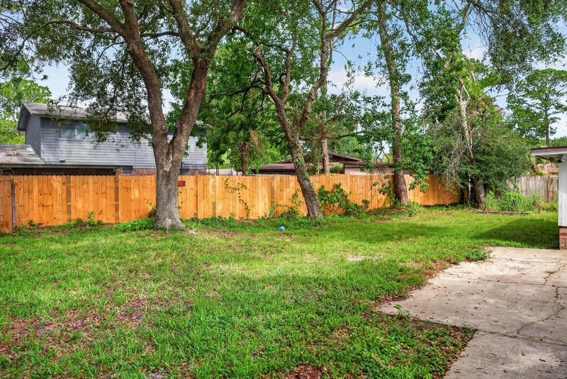 Backyard view with fence and shed at 9954 Larkdale Ct, Jacksonville, FL 32257