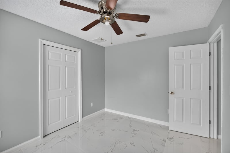 Bedroom with closet door and ceiling fan at 490 Hillside Dr, Orange Park, FL 32073