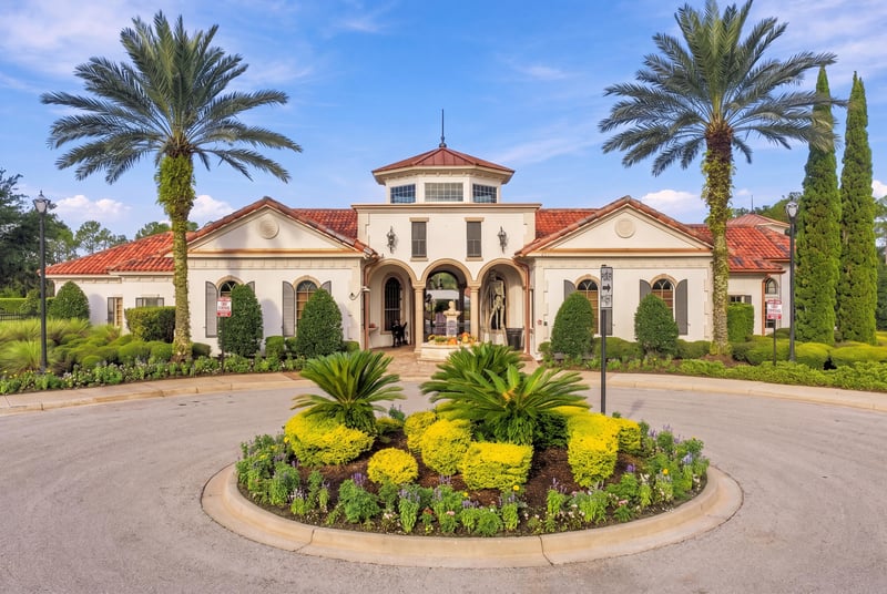 Community clubhouse exterior with palm trees in Murabella