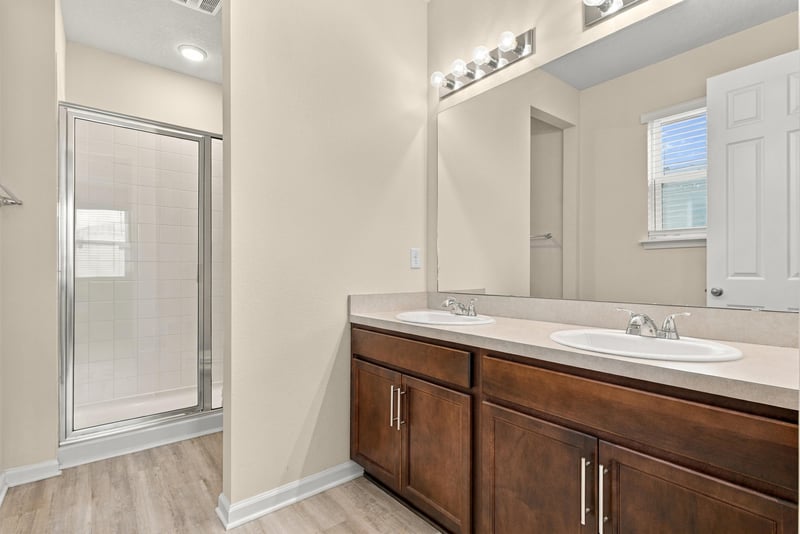 Bathroom vanity with dark wood cabinet at 7088 Mahogany Run Dr, Jacksonville, FL 32244