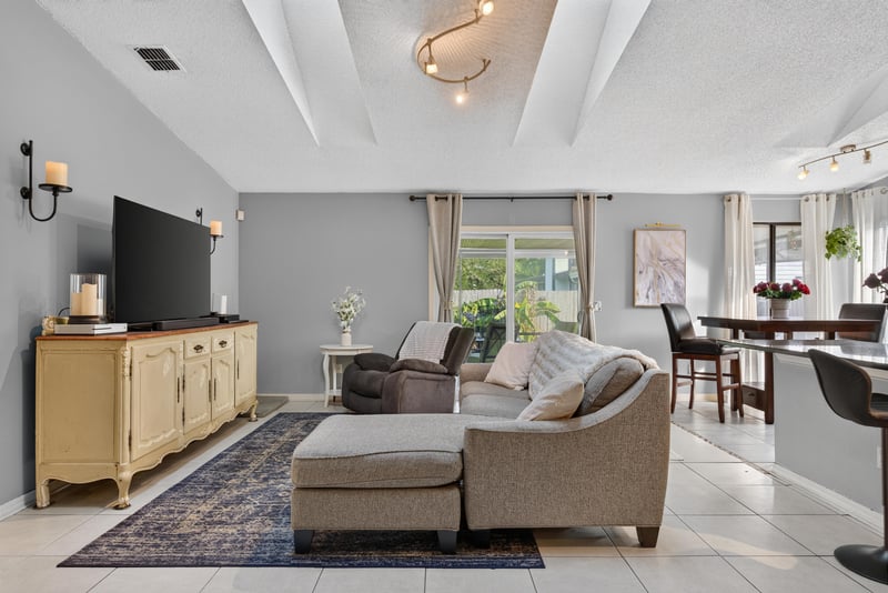 Living room with sectional sofa and TV stand at 13020 Medford Ln, Jacksonville, FL 32225