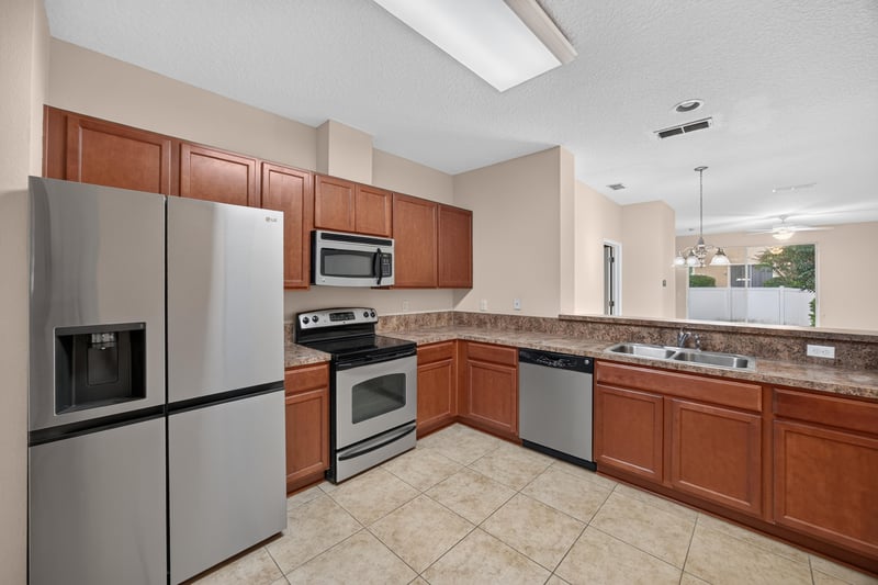 Kitchen view with refrigerator and microwave at 3762 Hartsfield Forest Cir, Jacksonville, FL 32277