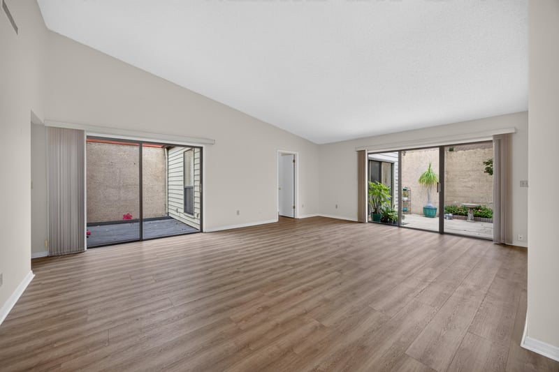 Living room with sliding glass doors to patio at 3407 Fairbanks Grant Rd N, Jacksonville, FL 32223