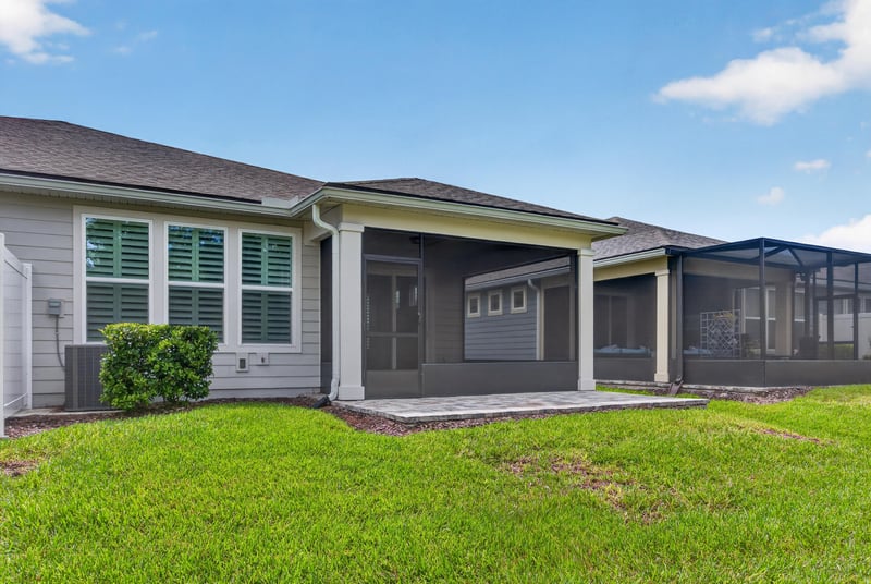 Rear exterior view of the covered porch and yard at 171 Oyster Shell Ter, Nocatee, FL 32081