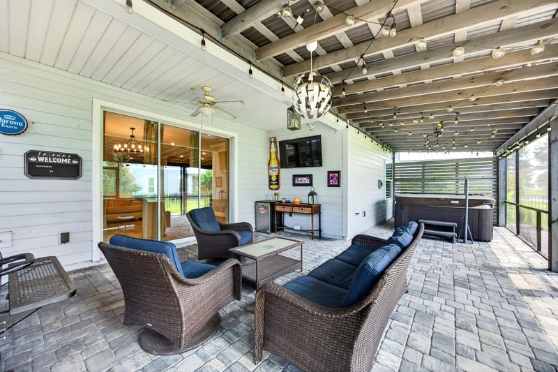 Covered porch with ceiling fans and outdoor living area at 91 Tilloo Ct, St. Johns, FL