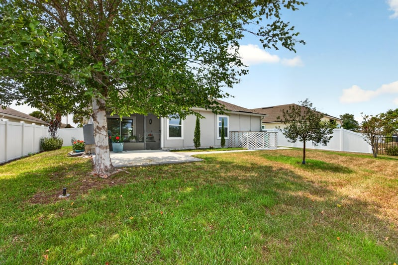 Side yard with tree and open grass at 85 Amia Dr, St. Augustine, FL 32086