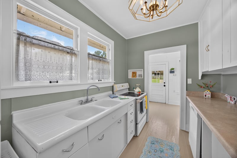 Kitchen with sink and side door at 101 N Lake St, Crescent City, FL