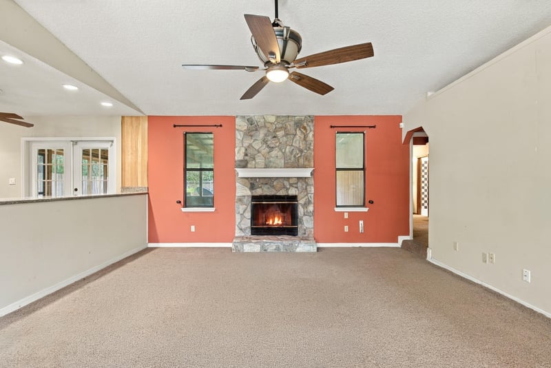 Living room with fireplace and coral accent wall at 2915 Trenton Ct, Orange Park, FL