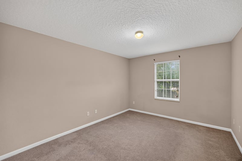 Carpeted bedroom with window at 3762 Hartsfield Forest Cir, Jacksonville, FL 32277