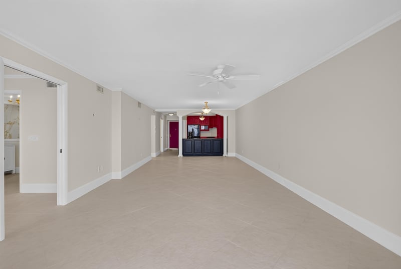 Hallway view toward kitchen with red door at 1301 1st St S