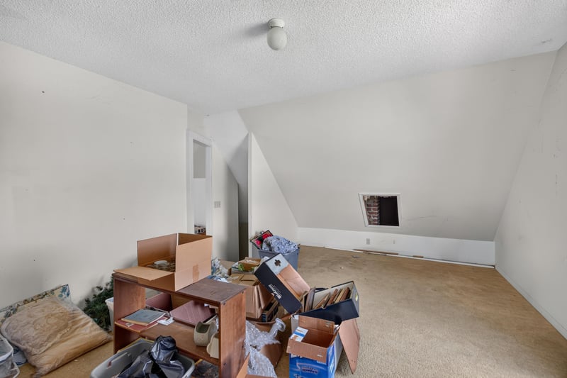 Attic storage room with boxes and sloped ceiling at 1173 US-17, Satsuma, FL 32189