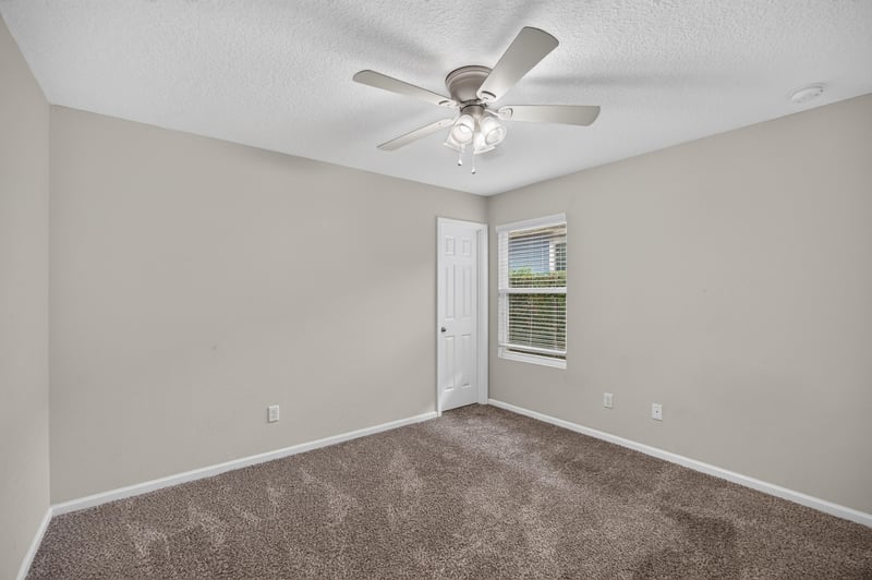 Empty carpeted room with window at 1002 Ingleside Ave, Jacksonville, FL 32205