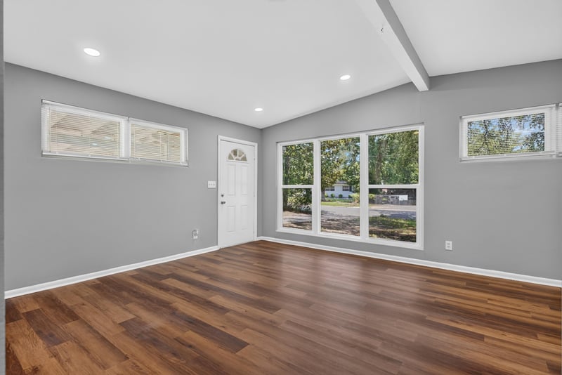 Living room with vaulted ceiling and windows at 1928 Montmarte Dr, Jacksonville, FL 32210
