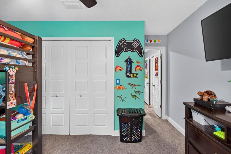 Bedroom closet with bunk beds and teal walls at 2817 Camel Cir, Middleburg, FL