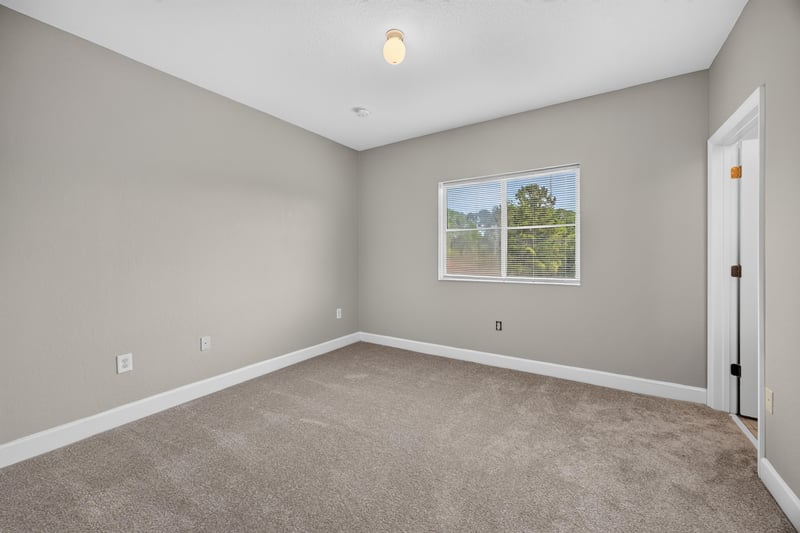 Carpeted bedroom with window at 9745 Touchton Rd, Jacksonville, FL 32246