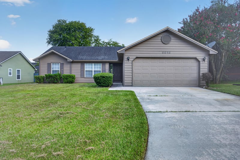 Front exterior with two-car garage and driveway at 6646 Shiloh Creek Dr