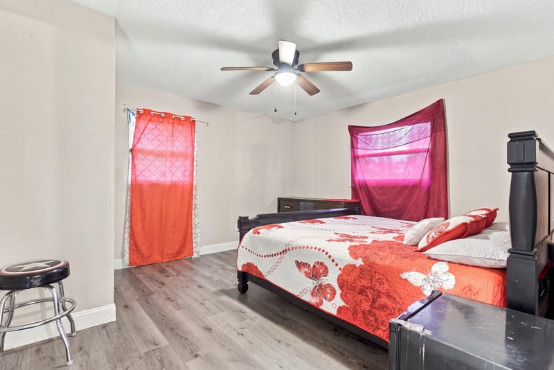 Bedroom with dark wood bed frame and curtains at 357 Dillon Dr, Orange Park, FL
