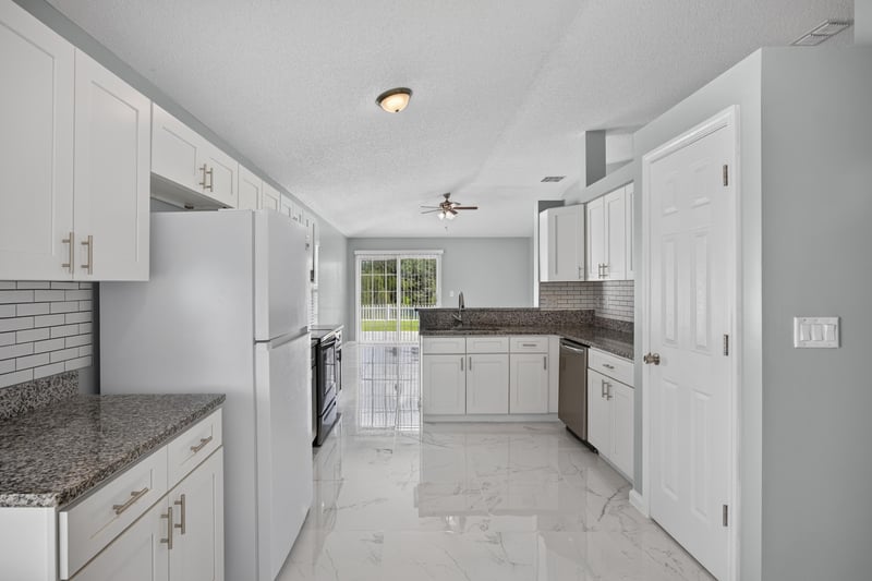 Kitchen view with white cabinetry and tile flooring at 490 Hillside Dr, Orange Park, FL 32073