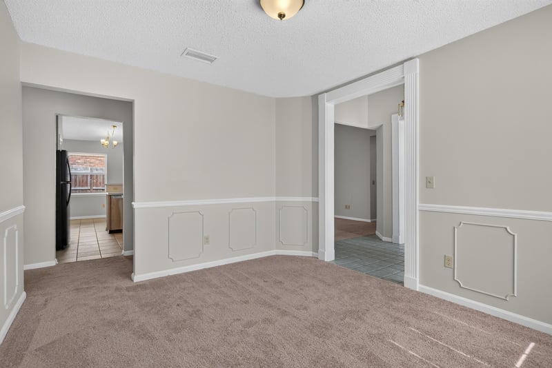 Empty room with doorways and chair-rail molding at 400 Ashcroft Landing Dr, Jacksonville, FL 32225