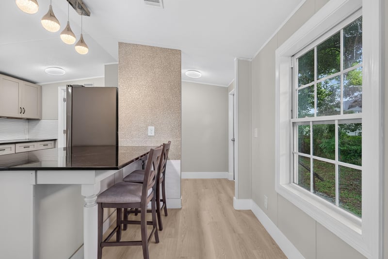 Kitchen island staged with bar stools at 4565 Appleton Ave, Jacksonville, FL