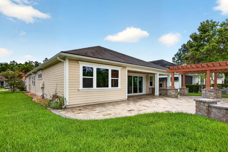 Back exterior with pergola and open lawn at 186 Freshwater Dr