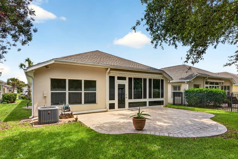 Backyard patio with AC unit and screened porch at 11225 Water Spring Cir, Jacksonville, FL 32256