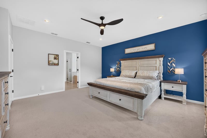 Primary bedroom with blue accent wall and dresser at 2354 Jennings Farm Dr, Middleburg, FL 32068