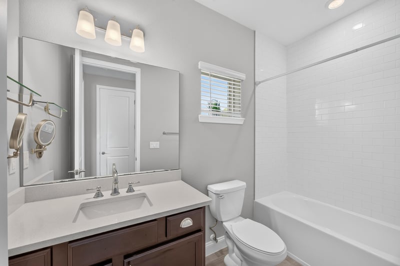 Bathroom with tub-shower and dark vanity at 91 Tilloo Ct, St. Johns, FL