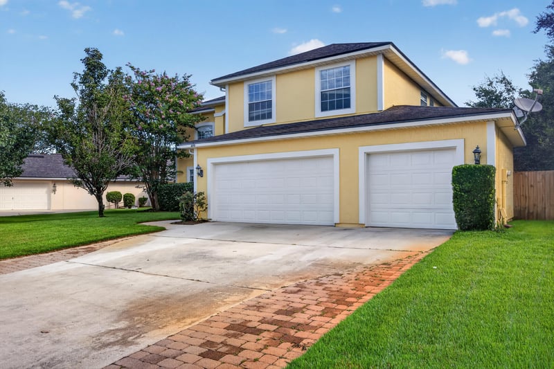 Front exterior, driveway and garage doors at 470 Sparrow Branch Cir, Jacksonville, FL 32259