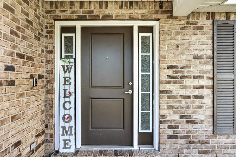 Front door with sidelights and brick entry at 9846 Olivia St, Jacksonville, FL