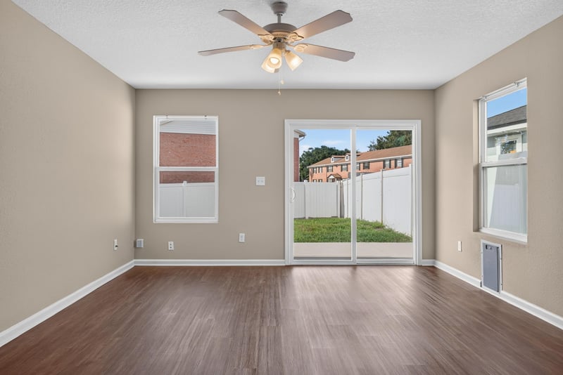 Living room with sliding glass door to backyard at 7253 Townsend Village Ct, Jacksonville, FL