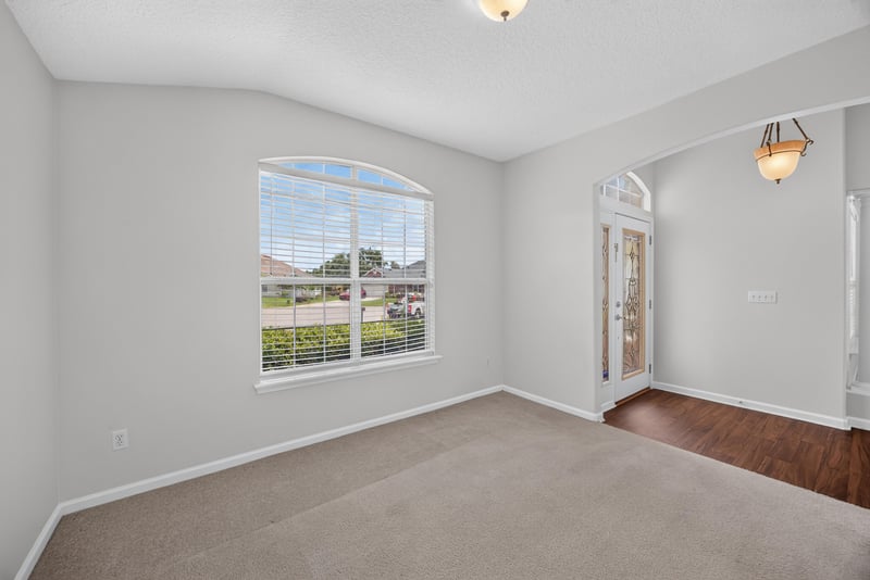 Empty room with window and door to patio at 2480 Ridge Will Dr, Jacksonville, FL 32246
