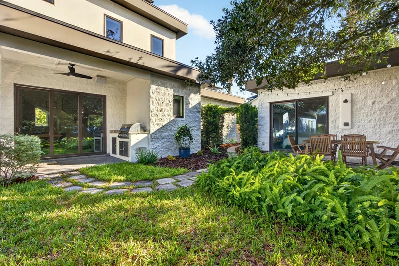 Side yard with sliding glass doors and outdoor kitchen at 722 3rd Ave N, Jacksonville Beach, FL