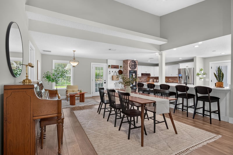 Kitchen island with dining table and piano at 1161 Whispering Pines Rd, Jacksonville, FL 32259
