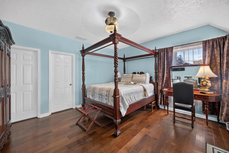 Bedroom with a four-poster bed and writing desk at 115 Cordova St, St. Augustine, FL