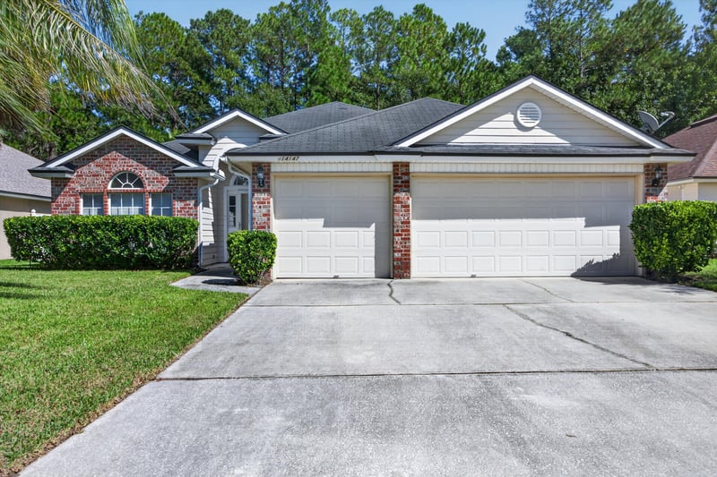 Front exterior with garage and driveway at 14147 Fish Eagle Dr E, Jacksonville, FL 32226