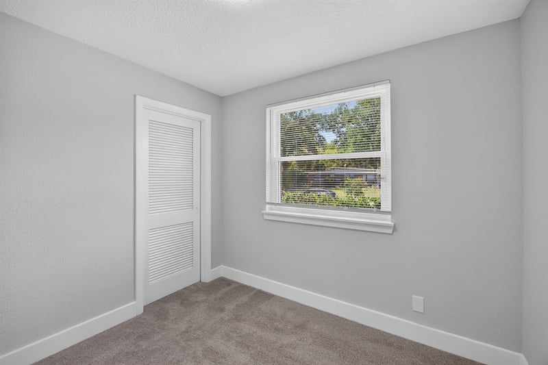 Bedroom with closet door and window at 6238 Randia Dr, Jacksonville, FL 32210