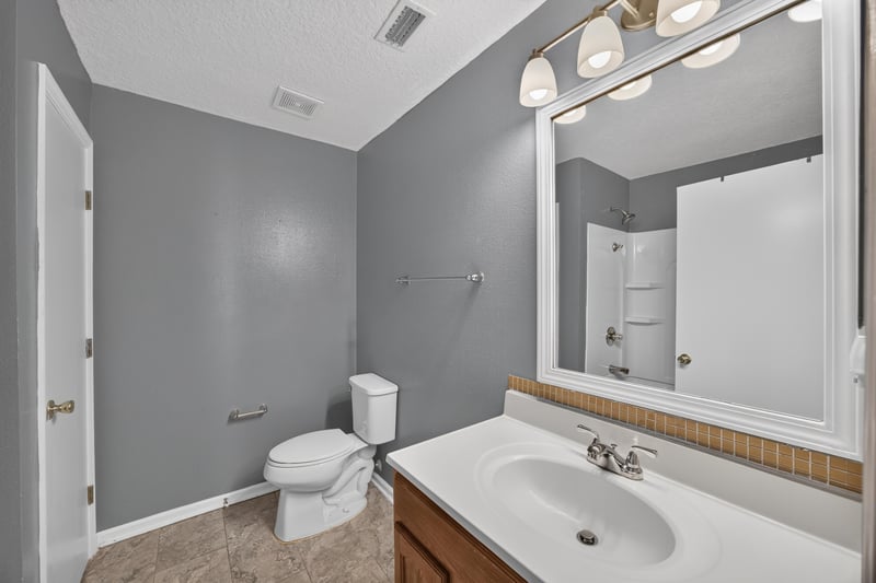 Bathroom with tub and grey walls at 2282 Justin Lake Dr, Jacksonville, FL
