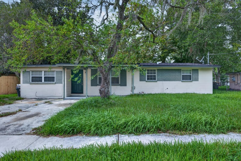 Front exterior with driveway and lawn at 5812 Tampico Rd, Jacksonville, FL 32244