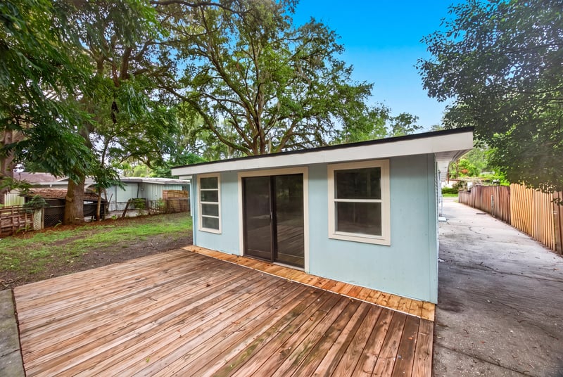 Rear exterior with wood deck and driveway at 3113 Kline Rd, Jacksonville, FL 32246