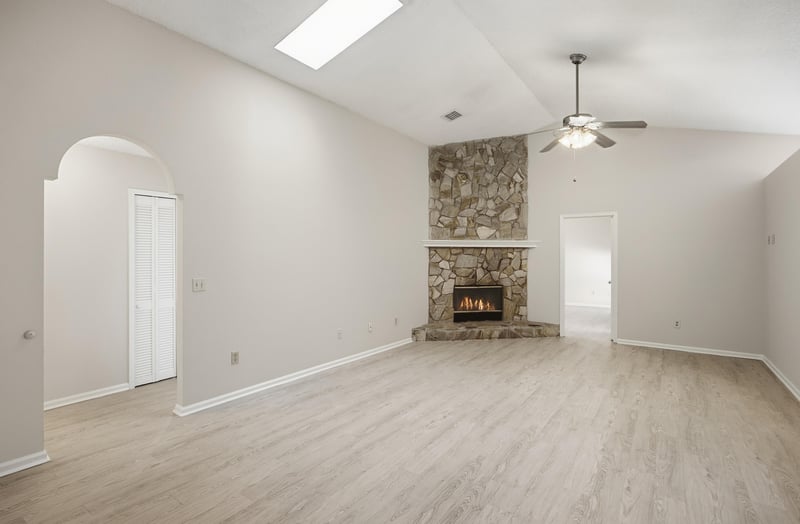 Living room with stone fireplace at 678 5th Ave N, Jacksonville Beach, FL 32250
