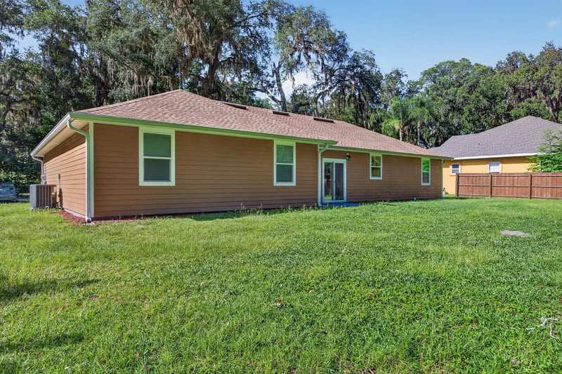 Rear exterior corner view with trees at 1012 Fruit Cove Rd, Jacksonville, FL 32259