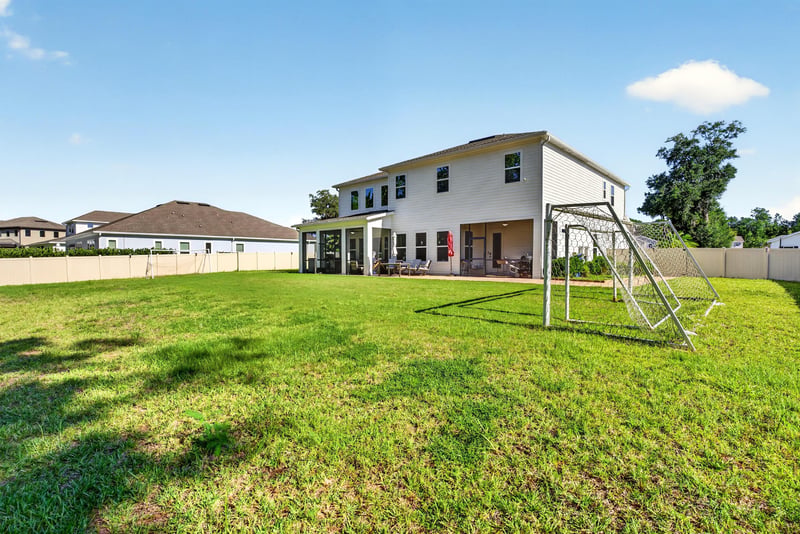 Backyard with swing set and fenced lawn at 22 Azura Point
